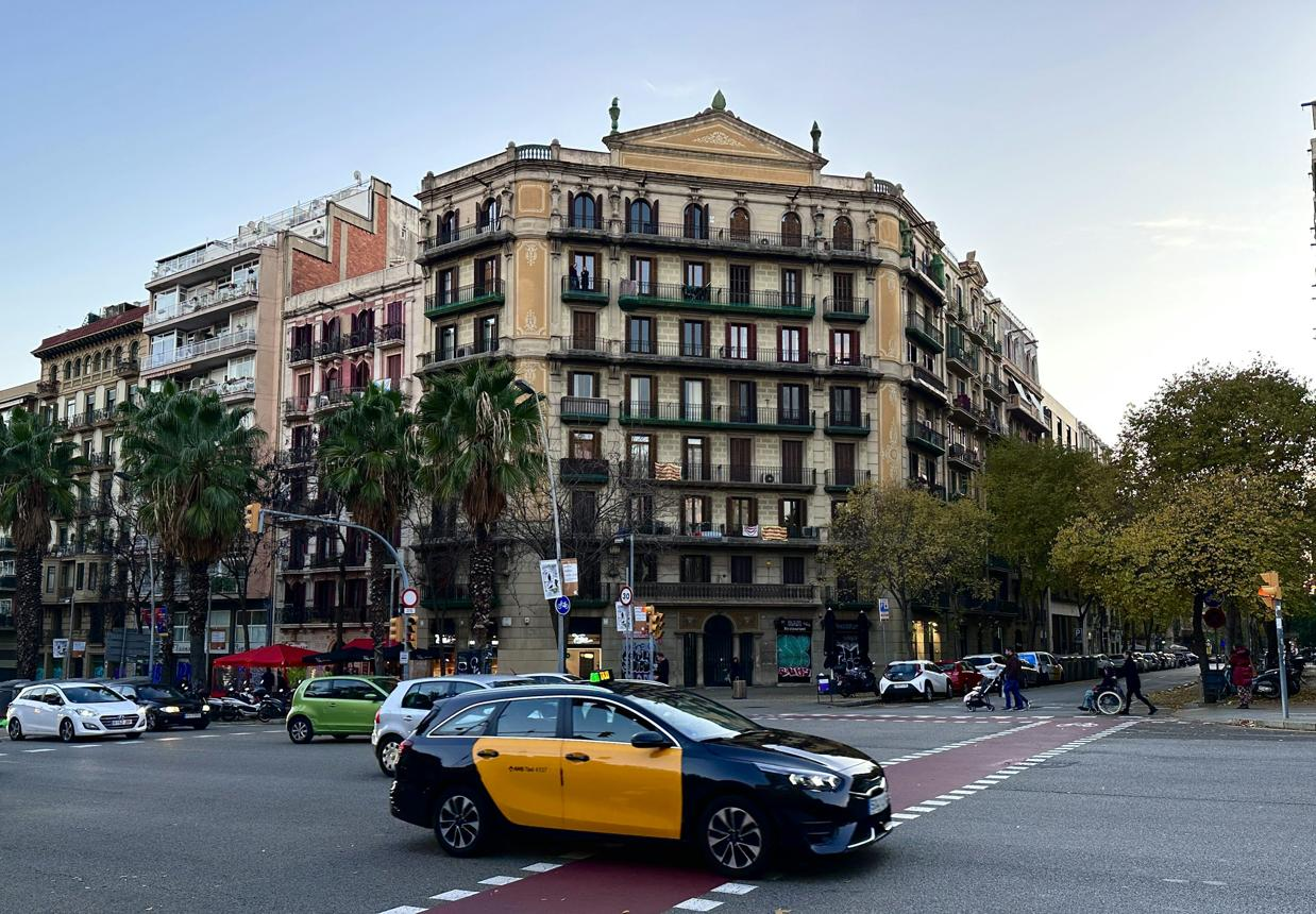 Classic yellow and black Barcelona taxi on city street